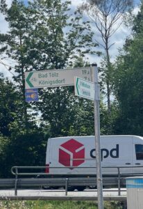 Wayfinding signs in Germany indicating direction and distance for cycling destinations.